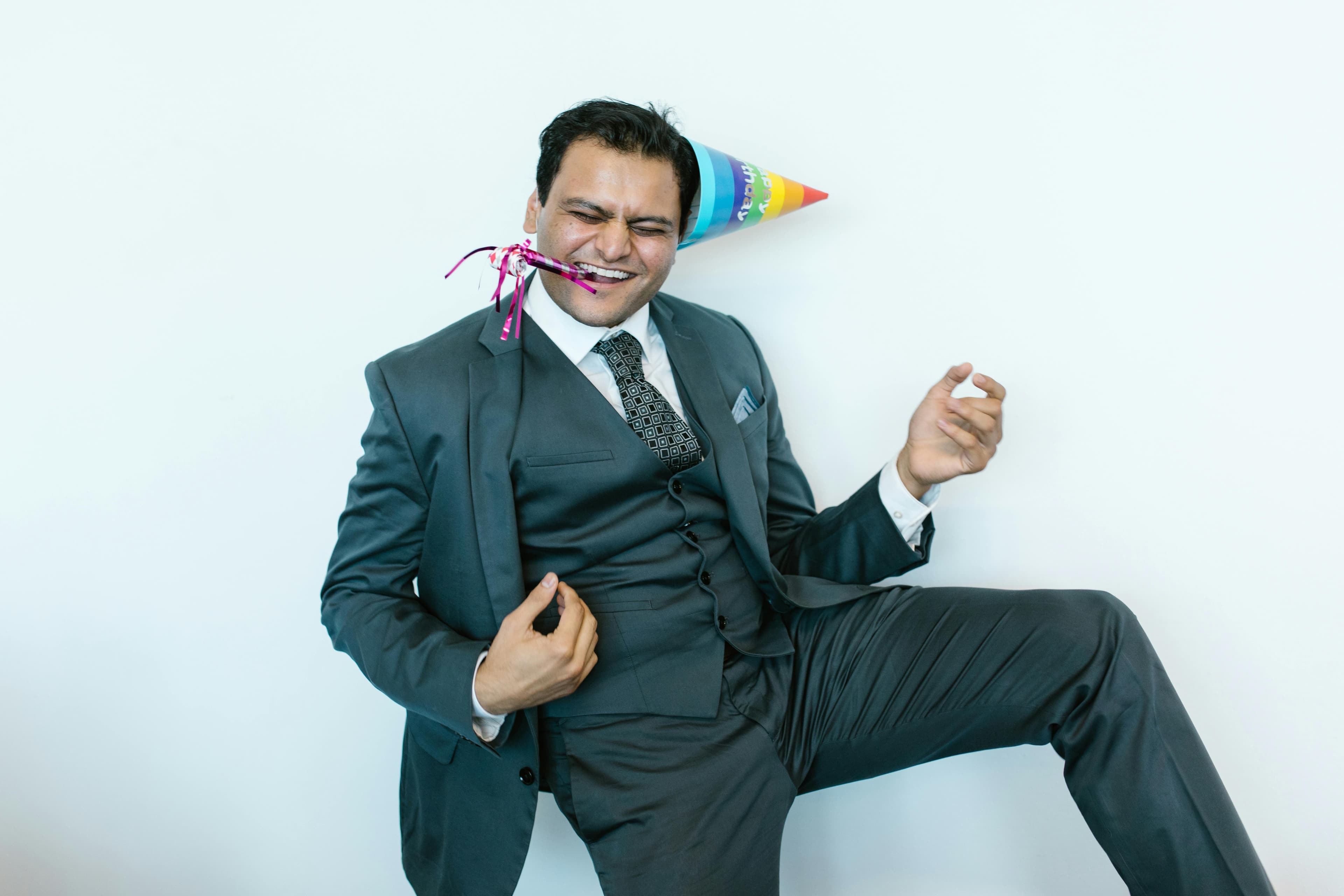 Corporate Events - man in suit jacket wearing a party hat