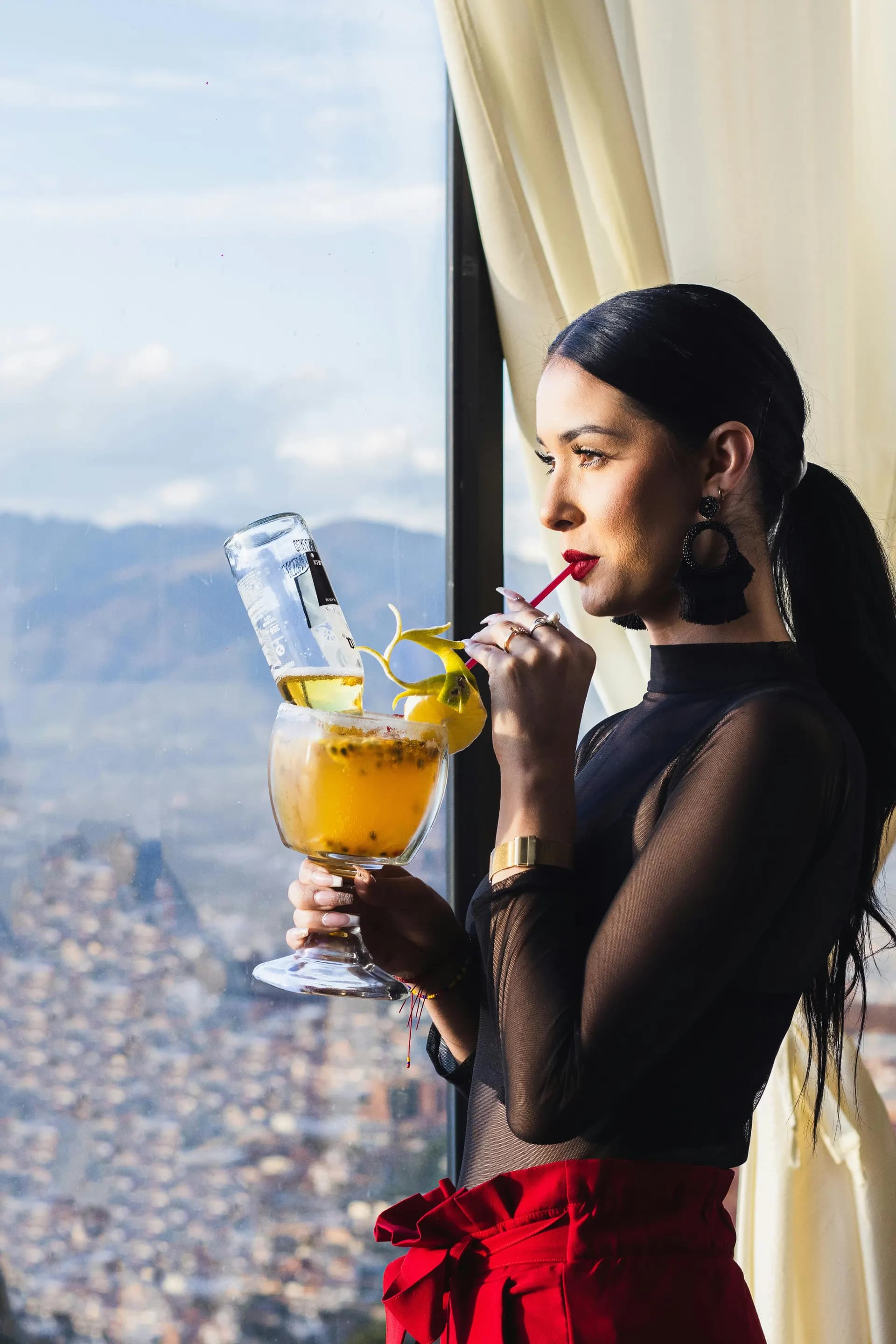 Private Parties - woman enjoying a large cocktail with city view