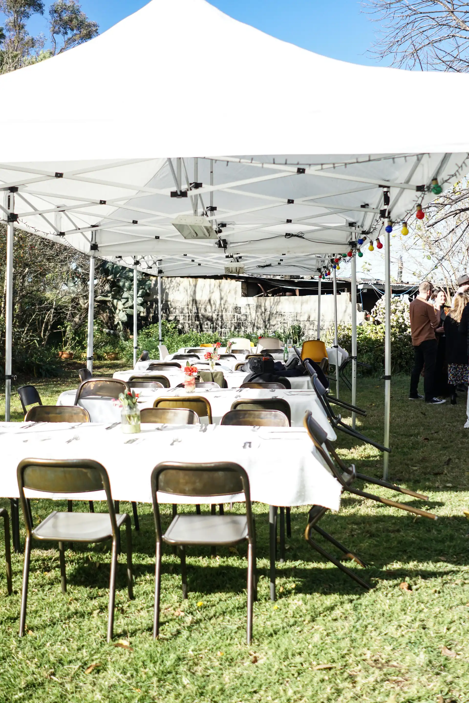 Weddings - tables and chairs under a tent outside