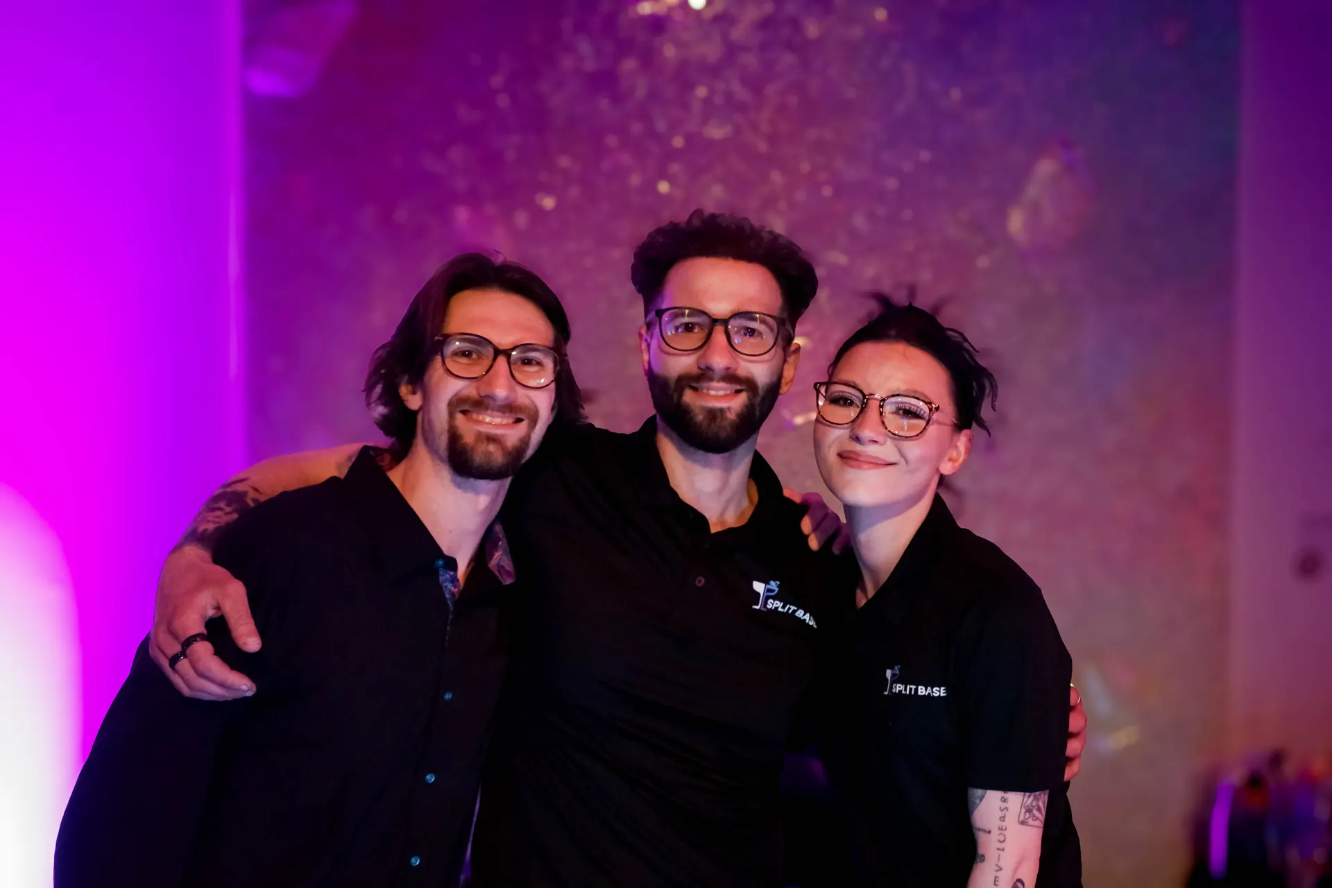 The Split Base crew together behind the bar at a showcase event